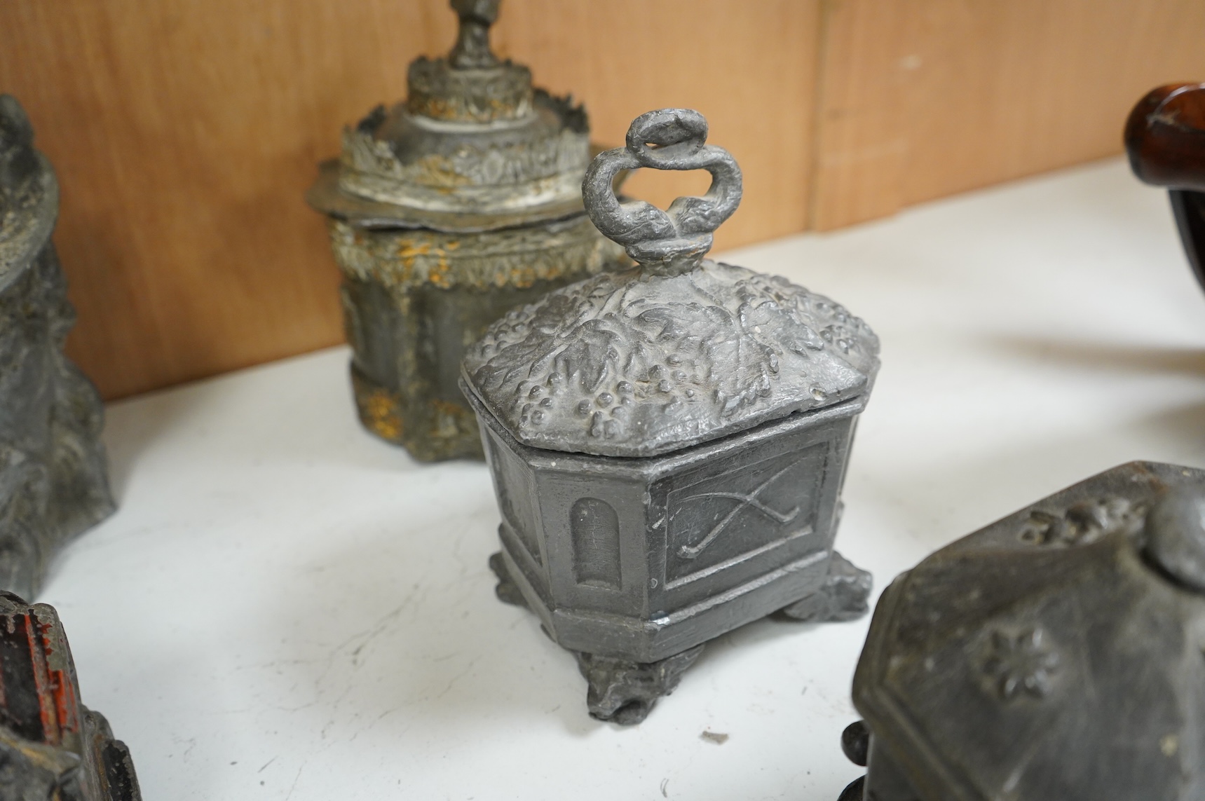 A collection of ten early 19th century lead tobacco boxes, one in the form of a goat’s head, tallest 20cm